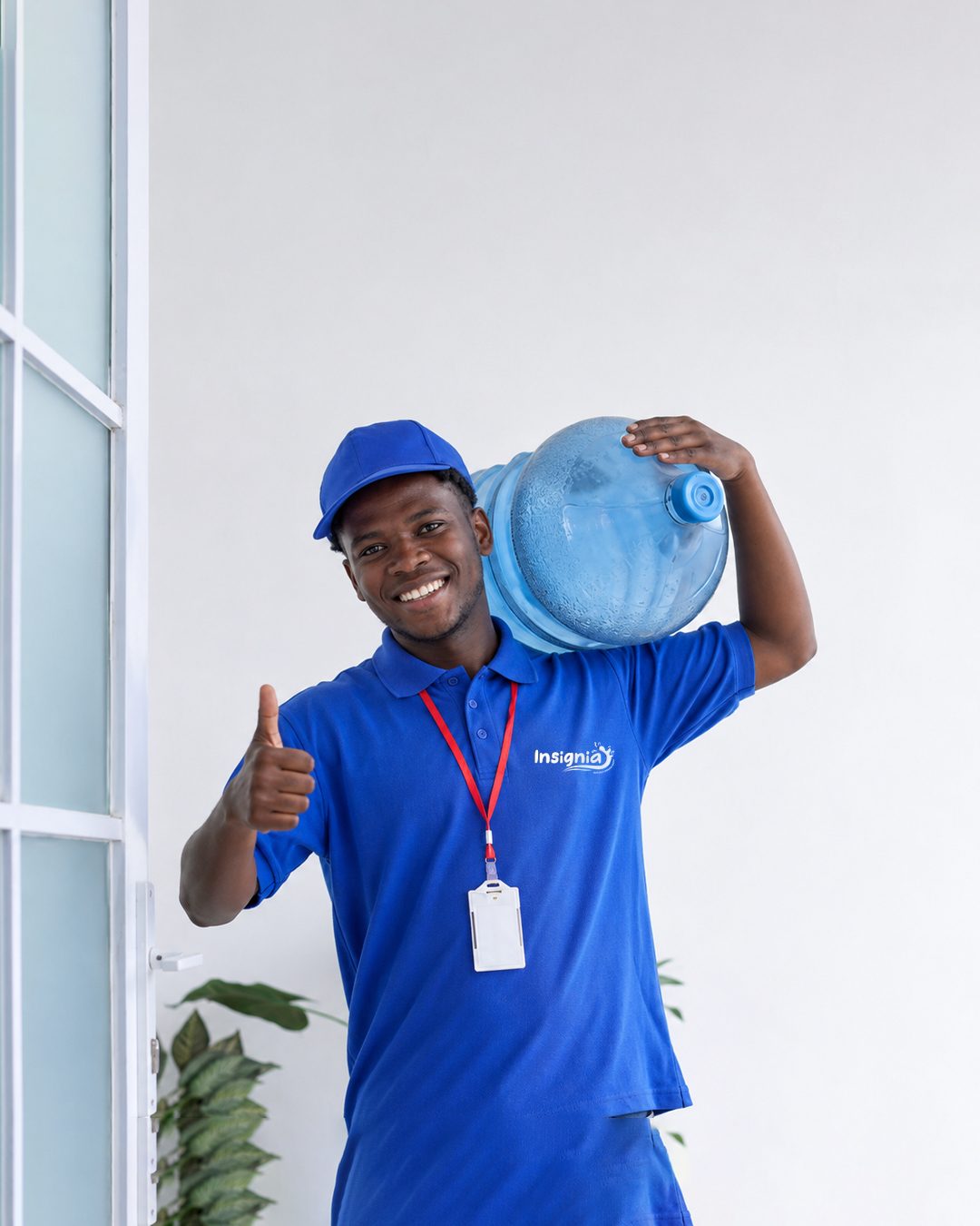 Uniformed Insignia H2O delivery rider carrying a branded 20L jerrycan on his shoulder in Kitengela